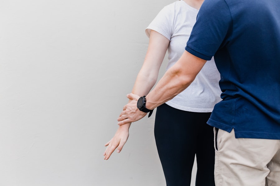 A physiotherapist assessing a patient's arm and wrist joint